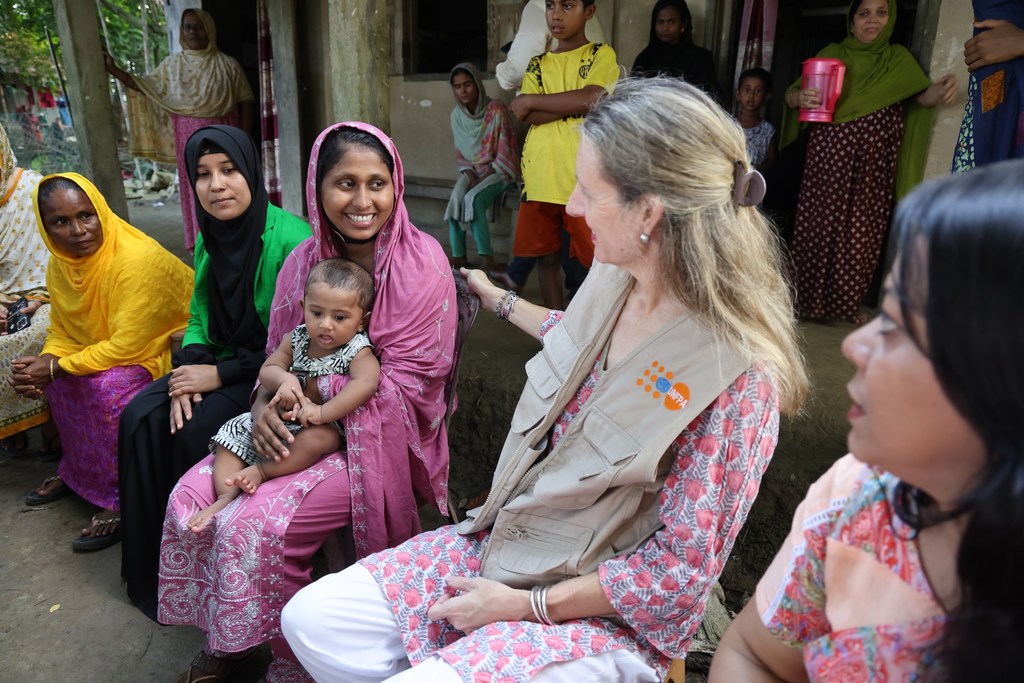 Anima Akhter, 24, proudly introduces her seven-month-old son to UNFPA Representative Catherine Breen Kamkong during a community visit to Bodipur village.